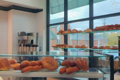 An assortment of breads and pastries on display in the store.