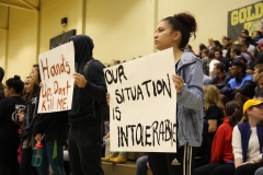 Students holding signs filed into the gym during the keynote speaker, Vernon Wall. Protestors then asked the audience to stand up in support. SAM CARAVANA / THE DEPAUW