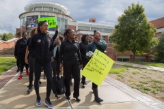 Student demonstrators march and chant as they leave the Greene Center for Performing Arts. The group chanted as they walked through the buildings serving lunch to DePauw Dialogue attendees. SAM CARAVANA / THE DEPAUW