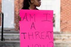 Sophomore Kaela Wright holds a sign in protest outside of the Union Building. Students of color silently protested at a family weekend event on Saturday morning. SAM CARAVANA /THE DEPAUW
