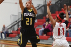 Sophomore standout Maya Howard (center) shoots over a defender's outstreched hand. DePauw continued its 12-game winning streak topping Denison 63-50 in double overtime. SAM CARAVANA / THE DEPAUW