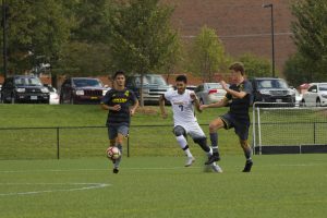DePauw's number seven, Chase Rollins, fights for the soccer ball during Saturday's game. ZACH TAYLOR / THE DEPAUW
