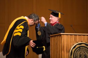 Chair of the DePauw University Board of Trustees, Marshall Reavis ’84, endows President Mark McCoy with the presidential medallion during the inauguration saturday.   SAM CARAVANA / THE DEPAUW