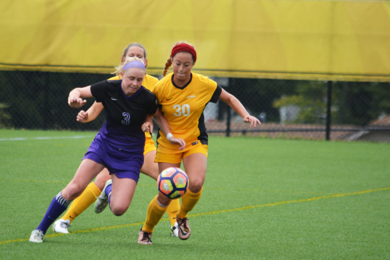 DePauw defender Dana Shedd fights for possession against Kenyon forward Maggie Smith. PHOTO COURTESY OF DEPAUW UNIVERSITY