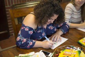 Freshman Maria Flores colors in a coloring book as a way of relieving stress from her everyday life. GERALD PINEDA / THE DEPAUW