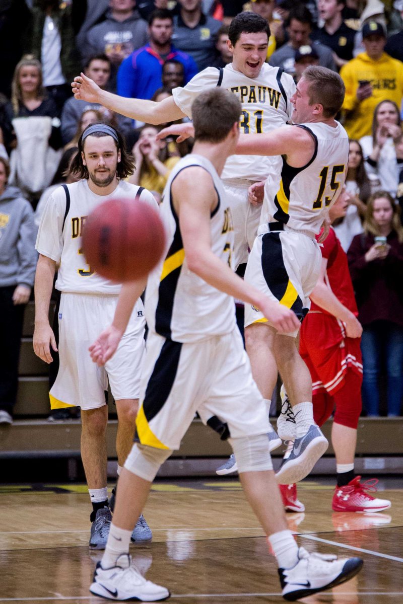Seniors Luke Lattner (center right) and Nate Jahn (right) chest bump in mid-air after the game. DePauw topped Wabash 70-50 in the final home game of the season. SAM CARAVANA / THE DEPAUW