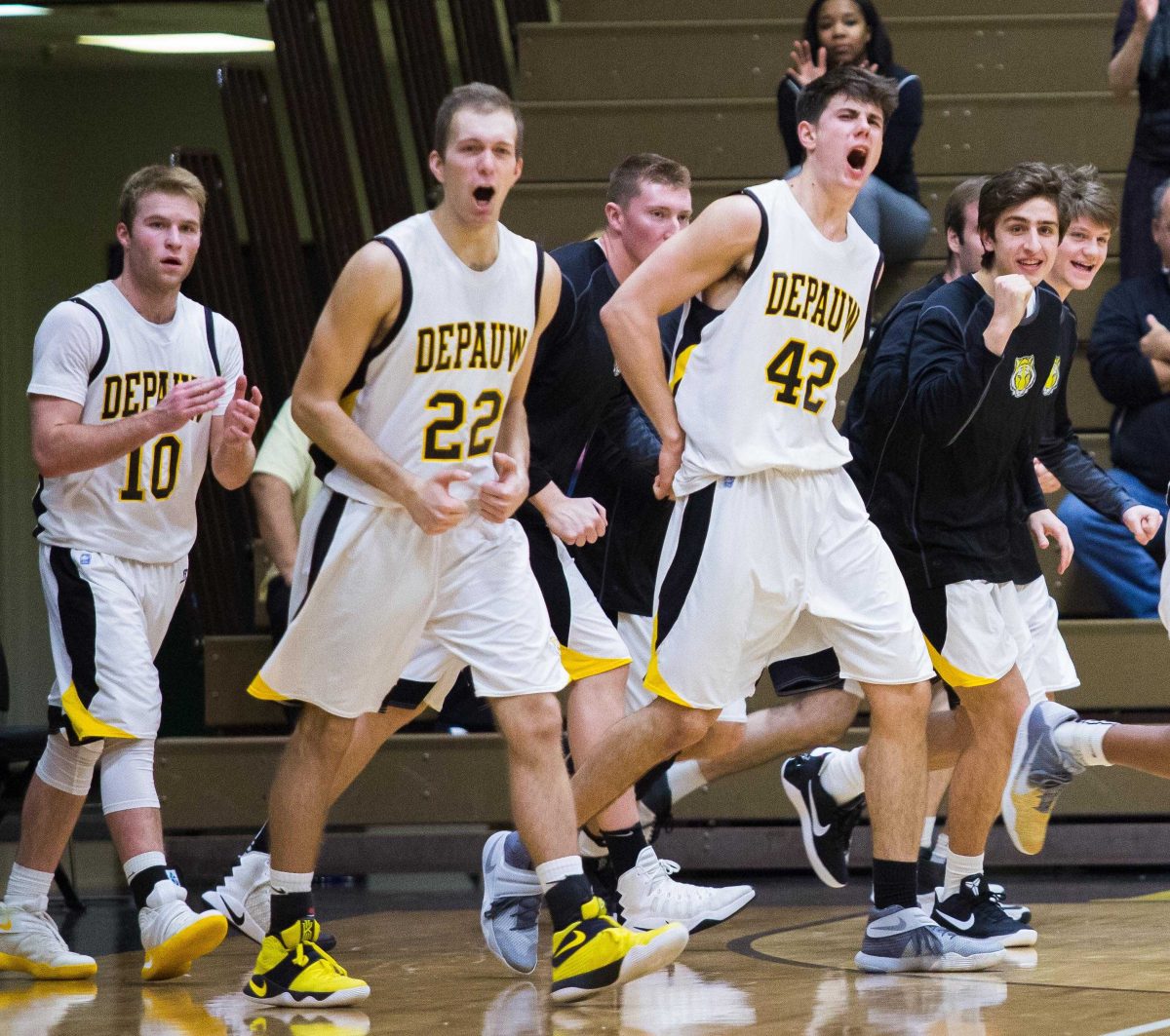 Members of the DePauw basketball team celebrate after senior Luke Lattner hit a last second three-pointer going into halftime. DePauw fell to Denison University 73-68 on Wednesday extending their losing streak to seven games. SAM CARAVANA / THE DEPAUW