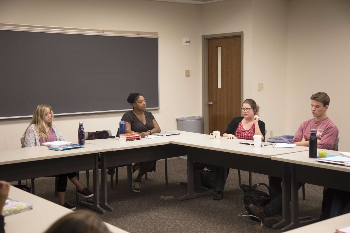 Assistant professor of Education studies, Rebecca Alexander (right-center) asks students to identify instances of white supremacy from her experience in Kenya in Assistant professor of English, Karin Wimbley’s (left-center) South African class. EMMANUEL KWAKYE / THE DEPAUW