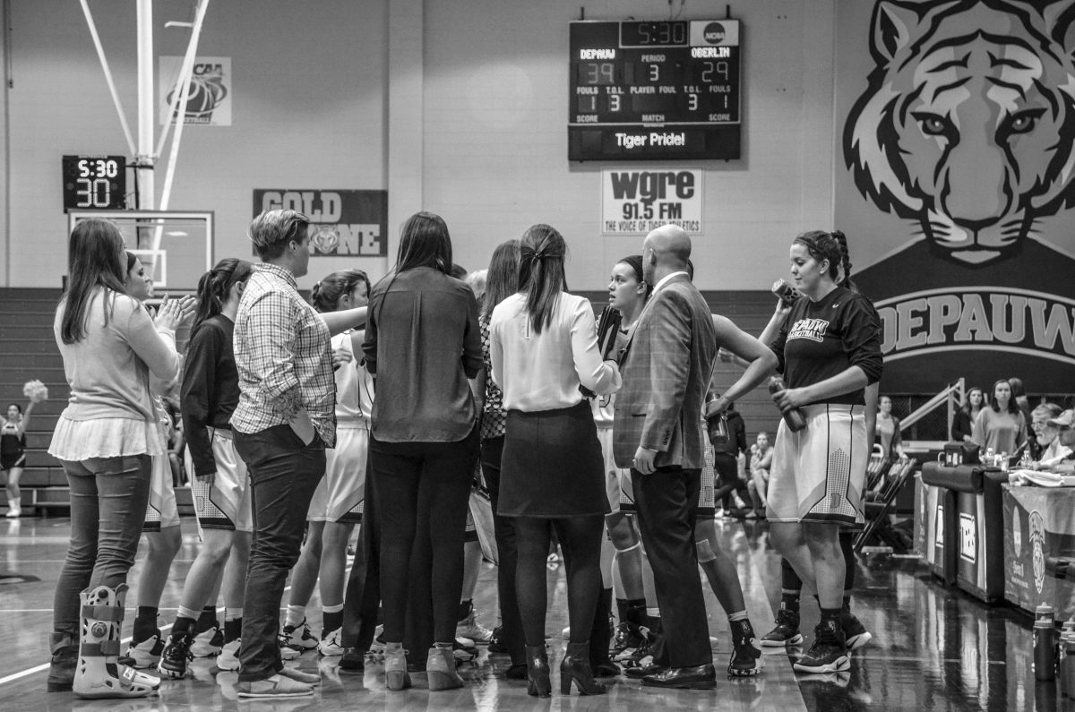 The team huddles together during the third period of the game. KYLE WINTERS / THE DEPAUW