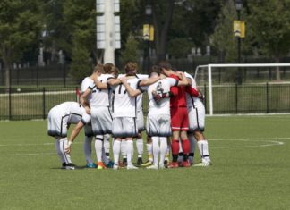 The Men's Soccer team huddles up before heading into overtime. REID COOPER