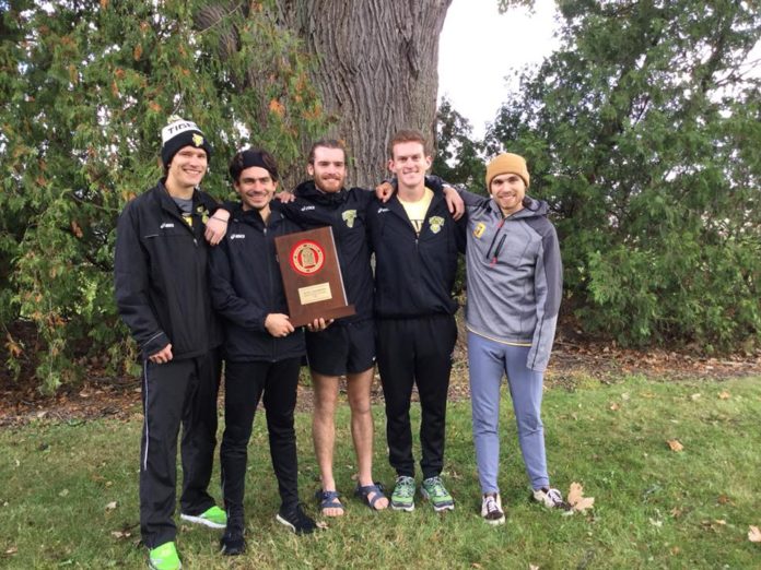 Seniors Nick Meszaros, Polo Burguete, Nathan Reed, Pierce Sheehan, and Josse Smith hold the Conference trophy following the team's win on Saturday. -- Megan Mannering