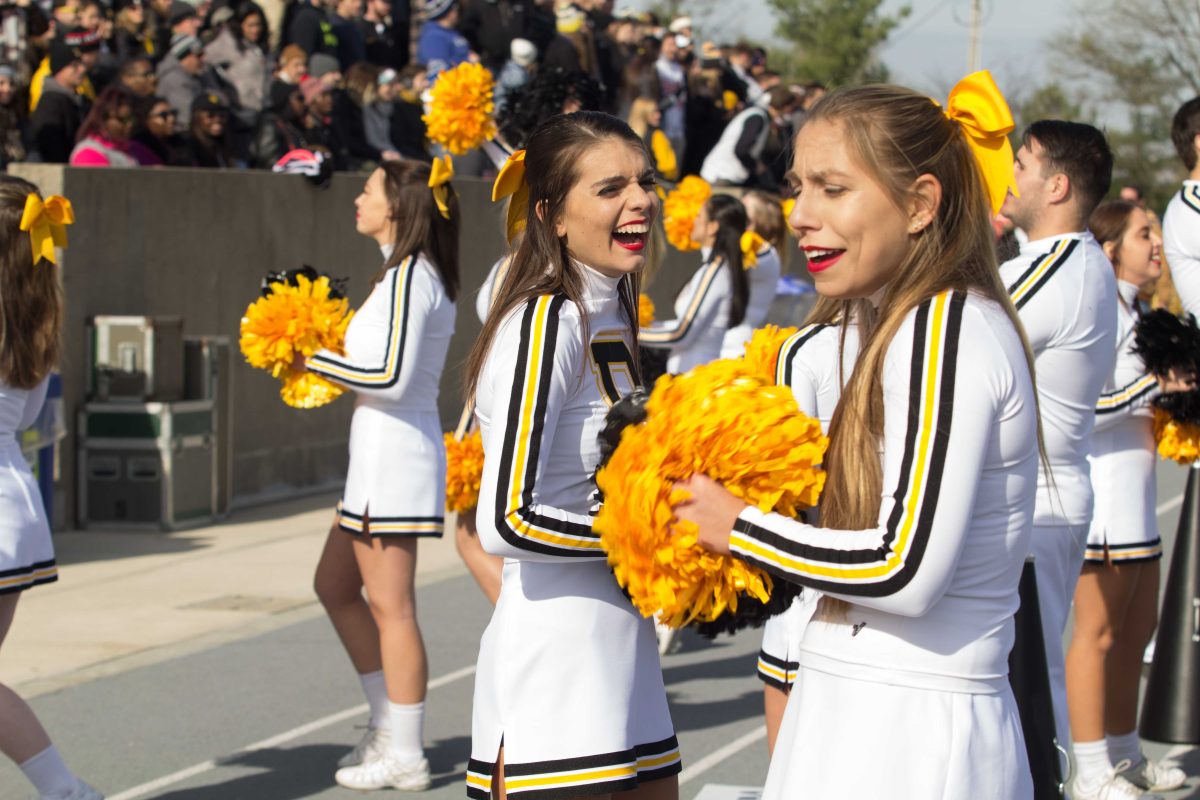 DePauw cheerleaders share a joke in between their cheers BYRON MASON II | THE DEPAUW