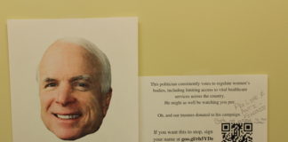 Signs about DePauw Board of Trustees donations to campaigns in the Women's Bathroom in the GCPA _ EMMA MAZUREK THE DEPAUW