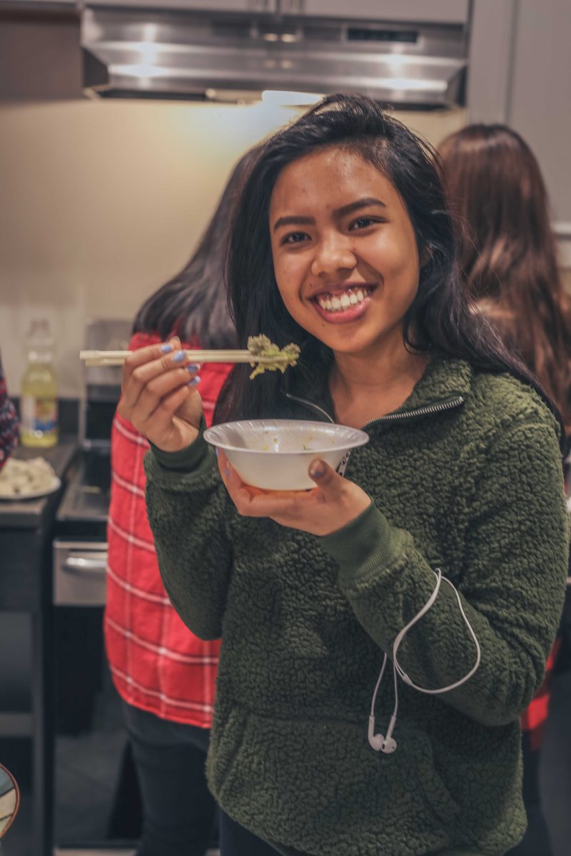 Junior Mi Jedar takes a bit out of a dish during the Chinese New Year celebration. NATALIE BRUNINI