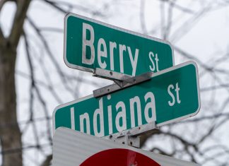 Green street signs at the corner of Berry St and Indiana St