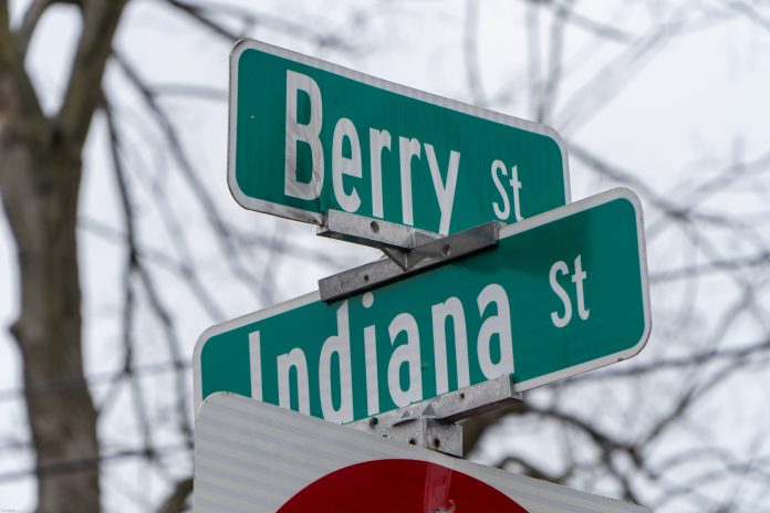 Green street signs at the corner of Berry St and Indiana St