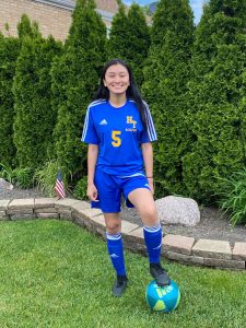 Atzihri Guido stand in her soccer uniform