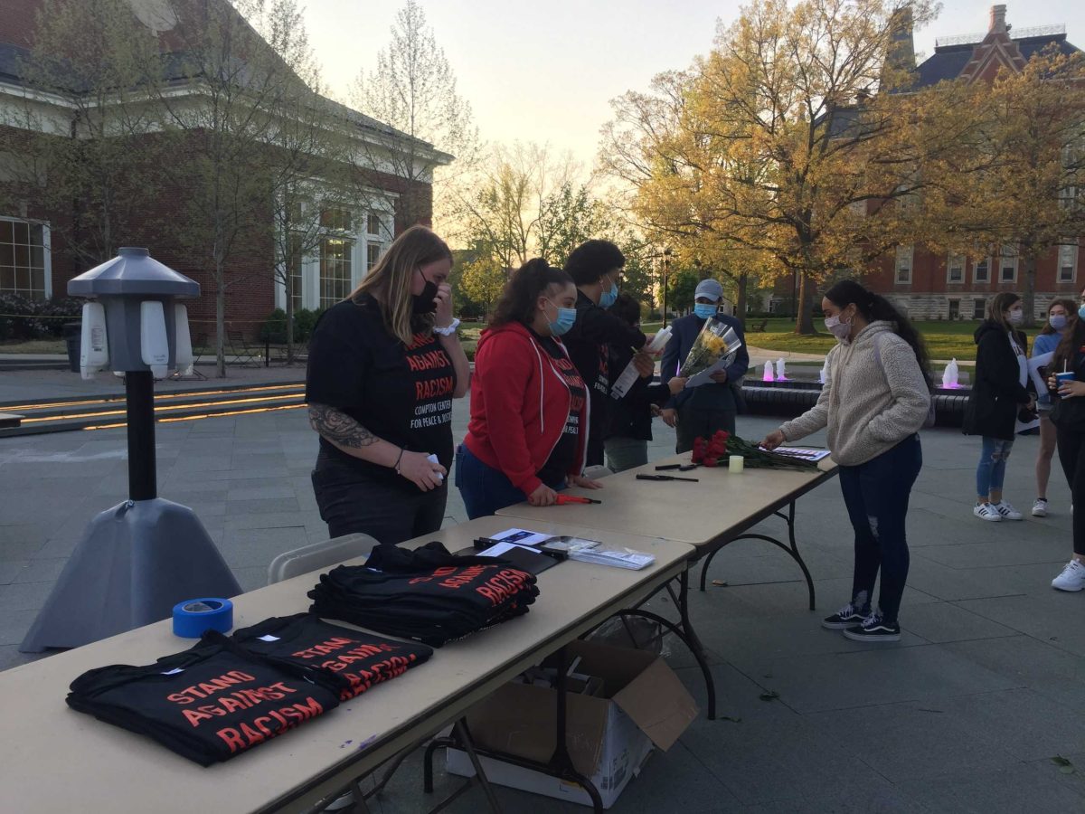 Volunteers from the Compton Center set up a table with t-shirts that read “Stand Against Racism,” pamphlets about anti-racism and detailing individuals’ rights when dealing with the police, and flowers and candles for the vigil participants.