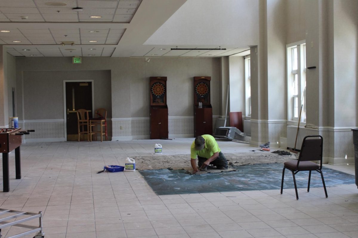 A construction worker working in the basement of Longden.                             Photo by Abigail Fathauer