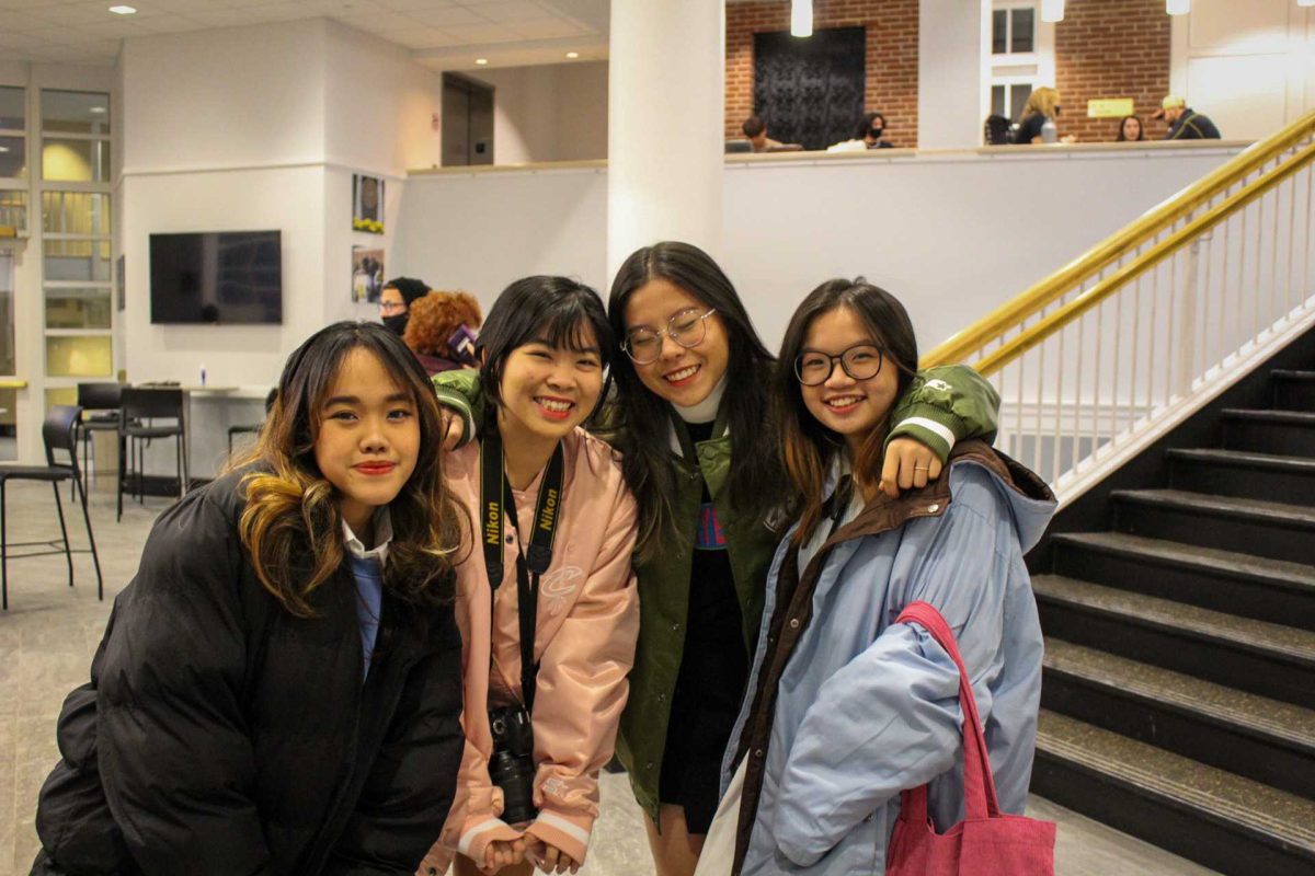 Khue Tran, Chi Nguyễn, Kaysel Ho, and Tran Nguyễn stand in the UB during the International Bazaar. Photos by Abigail Fathauer.