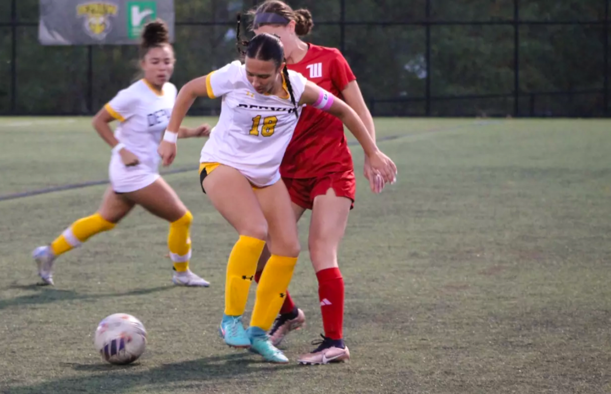 Sophia Patrey '27 intercedes a Wittenberg player with the ball during an Oct. 22 match at Reavis Stadium. (Photo courtesy of Fiona Sipple/DePauw Athletics)